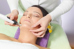 Woman having mesotherapy facial treatment at beauty salon. Close up